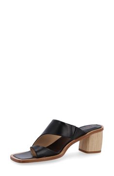 An asymmetric topline and stylish toe ring elevate a leather slide sandal balanced by a square toe and woodgrain block heel. 2 1/2" heel (size 39) Leather upper and lining/rubber sole Made in Spain Modern Mules With Block Heel And Heel Loop, Modern Open Toe Slides With Stacked Heel, Modern Slides With Stacked Heel And Open Toe, Modern Block Heels With Low Wooden Heel, Formal Open Toe Mules With Wooden Heel, Modern Low Block Heels With Wooden Heel, Chic Mules With Wooden Block Heel, Modern Slides With Stacked Heel, Formal Summer Clogs With Block Heel