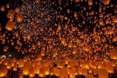 many lanterns are lit up in the night sky