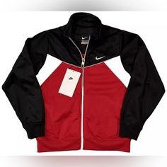 Get Your Little Athlete Ready For Any Sports Activity With This Nike Track Jacket. Made Of 100% Polyester, This Jacket Is Perfect For Activewear And Comes In A Stylish Black, White, And Red Color Combination. The Jacket Is Designed For Boys And Is Available In Size 7. This Track Jacket Is Ideal For Sports Enthusiasts And Is Perfect For Any Outdoor Activity. The Jacket Features A Brand Logo And Is Made With High-Quality Material To Ensure Durability. Get Your Child Ready For Any Sports Adventure Red Outdoor Sportswear Activewear, Nike Sportswear Tracksuit For Sports, Red Functional Winter Activewear, Sporty Red Activewear For Outdoor Activities, Red Sporty Activewear For Outdoor, Red Athleisure Activewear For Outdoor, Red Hooded Sportswear Activewear, Red Hooded Activewear For Sports, Functional Winter Gym Tracksuit