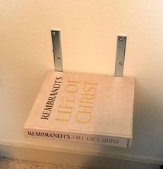 a book sitting on top of a white box with metal handles and the words, rembrandds in christ