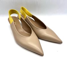 Item Color: Nude 40mm Leather Covered Heel Leather Upper Logo Elastic Slingback Strap Pointed Toe Leather Lining And Insole Leather Sole Fits True To Size Made In Italy Composition: 75% Calf, 19% Nylon, 3% Polyester, 3% Polyurethane Calf Leather Slingback Pumps With Leather Lining, Designer Slingback Pumps For Work, Spring Calf Leather Slingback Pumps With Leather Lining, Spring Calf Leather Slingback Pumps, Office Slingback Pumps In Calf Leather, Designer Slingback Pumps With Removable Insole, Ankle Strap Slingback Pumps With Leather Lining For Work, Leather Lining Slingback Pumps For Workwear, Cream Leather Slingback Pumps With Sculpted Heel