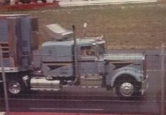 a large semi truck driving down a race track