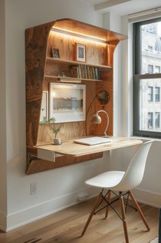 an office with a desk, chair and bookshelf in the corner near a window