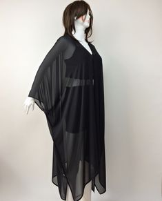 "This wonderful loose kimono is made of black silk georgette chiffon fabric. You can use this sheer plus-size cardigan with jeans or shorts. Also, it can wear as a beach cover-up on your swimsuit. This is a see-through sheer long jacket. Use it as casual wear. You will look fabulous when you wear this lightweight long caftan. This summer jacket would be a perfect gift for you or your loved ones. The boho solid kimono top is excellent, fun, and chic. It is a great gift for travel lovers. It is so Chic Black V-neck Kimono, Chiffon Long Sleeve Kaftan For Party, Long Sleeve Chiffon Kaftan For Party, Black Long Kimono For Beach Cover-up, Long Sleeve Chiffon Kaftan For The Beach, Long Sleeve Chiffon Kaftan For Spring, Sheer Black Cover-up For Spring, Black Sheer Cover-up For Spring, Elegant Sheer Cover-up For Party