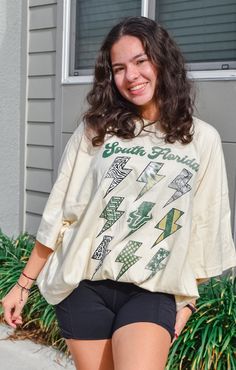 Shopping for new, bold game day tees? We’ve got you covered! The USF “FLASH” Oversized Tee is a must-have! This striking design is perfect for everyday and gameday. The front features the school name, logo, and mascot with a fun mix of patterns to complement your school colors. This tee is super soft and lightweight, keeping you cute and comfy with its trendy, oversized fit. Pair with biker shorts and sneakers for a trendy gameday look! Details: *OFFICIALLY LICENSED* Lightweight Soft Very Oversi Oversized Collegiate Short Sleeve T-shirt, Oversized Orange T-shirt With Letter Print, Oversized Urban T-shirt With Letter Print, Urban Oversized T-shirt With Letter Print, Oversized Game Day T-shirt With Screen Print, Florida Woman, Trendy Clothes For Women, School Colors, Southern Style