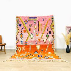 an orange and pink rug on the floor