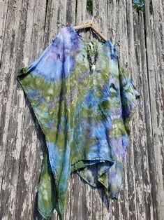 MONET Ice Dye Mini Kaftan, Beach Poncho or Tunic,  Regular or Plus Color Combo Name: ICE DYE MONET green-blue (looks like purple) Modeled in another color combo - a size Regular. I am 5'3", a size small. NECKLACE: See my Jewelry Section! This poncho/mini kaftan has a V-neckline and an armhole opening on the sides. The fabric is pre-shrunk super soft 100% woven rayon fabric. No need to iron it out of the dryer (I just dyed this beauty, and took it out of the dryer - it looks perfect!). Also, the wrinkles come out when hung for a while. 100% super-soft woven rayon Pre-Shrunk Machine wash and dry - the label calls for dry cleaning, but we have washed and dried it. Measurements:  REGULAR ONE SIZE;  Fits S-XL  41" wide -29½" between side stitching, 32" long PLUS ONE SIZE: 48" across, 37" across Multicolor Poncho For Beach Cover-up In Summer, Green Hippie Kaftan For The Beach, Multicolor Long Sleeve Poncho For Beach, Multicolor Long Sleeve Poncho For The Beach, One Size Blue Cover-up For Festival, Multicolor Poncho For Beach Cover-up, Multicolor Poncho For Summer Beach Cover-up, Multicolor Summer Poncho For Vacation, Spring Multicolor Poncho For Beach