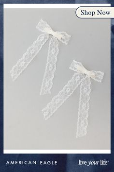 two white lace garters with bows on them