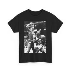 It's another legendary shot of a legendary player. Let your street wear tell the story with this iconic look Throwback Graphic Print Tops For Sports Events, Retro Sports T-shirt With Graphic Print, Throwback T-shirt With Sublimation Print For Fans, Vintage Graphic Print T-shirt For Sports Events, Throwback Graphic Print Tops For Streetwear, Retro Sports Graphic Print T-shirt, Fan Apparel T-shirt With Graphic Print For Streetwear, Fan Apparel Graphic Print T-shirt For Streetwear, Streetwear Fan Apparel Graphic T-shirt