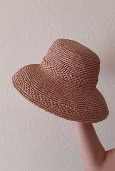 Women's hat crocheted from viscose raffia in beige color. Raffia is a natural, environmentally friendly, biodegradable and hygroscopic material. The hat is stylish, comfortable, transpirable, light and very durable, it will last more than one year. Perfect for the summer. The last row is specially reinforced and keeps its shape perfectly. Dimensions: Head circumference 57-58 cm Hat brim 10 cm Care: Do not wash. Wipe it with a clean damp cloth. In case it is wrinkled or out of shape, you can steam it with an iron at medium temperature. Can be sent to you immediately after ordering. If you have any questions regarding this hat, feel free to ask. You can also find me on Instagram @liana.knitting.craft Gardening Hat, Raffia Hat, Beige Color, Sun Hats, Hats For Women, Floppy Hat, Biodegradable Products, Caps Hats, Accessories Hats