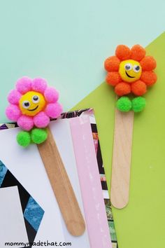 two popsicle flowers sitting on top of each other