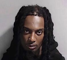 a man with dreadlocks is looking at the camera