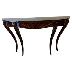 a wooden table with marble top and curved legs