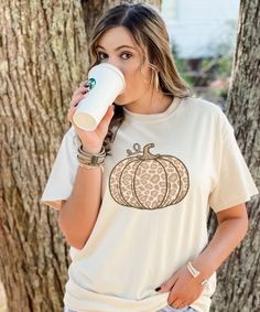 Fall is almost here! That means pumpkins, pumpkin spice, and cool crisp air! Fall is the best time of the year. This leopard pumpkin tee has a variety of options. We offer different tee styles and even different colors! The options are endless. This tee is great for running errands or even sitting in the comfort of your own home sipping on that pumpkin spice latte. Pumpkin Graphic, Leopard Pumpkin, Fall Graphic, Crisp Air, Pumpkin Shirt, Graphic Tee Shirt, Fall Shirt, Pumpkin Design, Classy Women