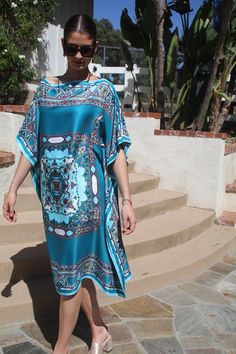 Elegant silk tunic in beautiful turquoise with an artistic center design, all surrounded by a beautiful, matching border, is a real standout.  An item to be worn daytime or evening.  Wear alone as a dress or pair it with pants, leggings or skirts.   The width is 40 inches, edge to edge or 80 inches around the body.  The seams are 5 inches from the edge, giving 60 inches around the body . The side seams can be adjusted if desired.  The length is 39 inches.   Hand wash or dry clean. Silk Tunic Dress For Beach Cover-up, Bohemian Silk Kaftan For Beach Cover-up, Turquoise V-neck Kaftan For Summer, Blue Silk Embroidered Kaftan, Blue Silk V-neck Kaftan, Turquoise Dress, Silk Tunic, Tunic Blouse, Womens Tunics