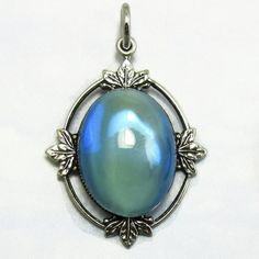 Vintage Glass Pendant Blue Opal Cabochon in Silver Art Deco Setting D-44 Vintage Iridescent Gemstone Jewelry, Vintage Gemstone Cabochons For Gifts, Collectible Iridescent Cabochon Jewelry, Silver Round Cabochons For Formal Use, Round Silver Cabochons For Formal Use, Vintage Opal Oval Cabochon Jewelry, Vintage Opal Jewelry With Oval Cabochon, Vintage Oval Cabochon Opal Jewelry, Vintage Oval Cabochon Moonstone Jewelry