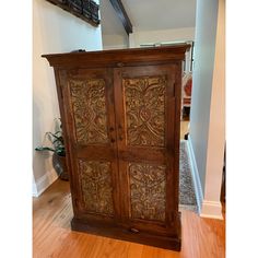 an old wooden armoire sitting on top of a hard wood floor