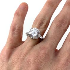 a woman's hand with a diamond ring on it