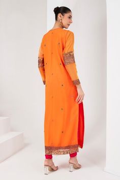 Orange full sleeves A-line kurta with mughal fleur embroidered yoke using sequins, cutdana, thread and nalki highlights. Paired with a fuchsia pink churidar and a bloom floret embroidered dupatta. - Aza Fashions Long Sleeve Traditional Wear With Mirror Work For Diwali, Diwali Long Sleeve Traditional Wear With Mirror Work, Diwali Traditional Wear With Mirror Work And Long Sleeves, Traditional Anarkali Set With Mirror Work And Long Sleeves, Long Sleeve Chanderi Kurta With Mirror Work, Traditional Chanderi Long Sleeve With Resham Embroidery, Long Sleeve Georgette Kurta With Zari Work, Unstitched Long Sleeve Kurta With Mirror Work, Traditional Long Sleeve Chanderi With Resham Embroidery