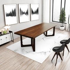 a dining room table with three chairs in front of it and artwork on the wall