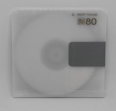 a close up of a white disk with a black label on the front and back