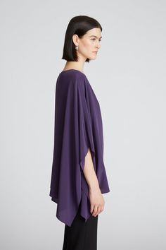 DETAILS Crafted in our signature crepe de chine fabrics, the Wendy top features a silky-smooth texture and flowy drape. It features a rich, deep palette that’s perfect for the season. Framed by an alluring neckline, this style’s fluid silhouette transitions with caftan sleeves. Crew neck Cape sleeve Hip length Non stre Elegant Purple Silk Blouse, Silk Draped Evening Tops, Purple Silk Evening Blouse, Silk Blouse For Evening, Elegant Draped Silk Top, Chic Purple Silk Top, Purple Silk Evening Top, Chic Flowy Top For Evening, Chic Flowy Evening Top