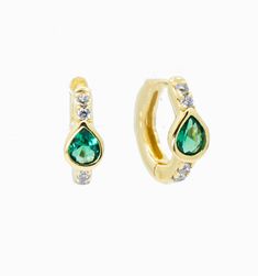 A bold green cubic zirconia adorns this delicate huggies. The chunky frame makes these beauties stand out but they're still subtle enough to wear everyday. Dress up your date night with this sultry pair of earrings or wear them to complement your eyes.Hoop size: 10mm Everyday Green Teardrop Hoop Earrings, Gold Teardrop Hoop Earrings With Emerald, Green Teardrop Hoop Earrings, Green Emerald Huggie Earrings, Green Teardrop Nickel-free Hoop Earrings, Simple Gold Earrings, Zodiac Bracelet, Zodiac Necklaces, Bar Bracelets