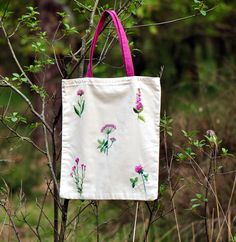 This is an original hand-embroidered 100 % cotton shopping bag with pink wild flowers' pattern. It does have a cotton lining too. The pattern is just on the one side of the bag. Measurements: 41 x 39 cm I heartily recommend buying this craft :) Embroidered Cotton Eco-friendly Bags, Eco-friendly Embroidered Cotton Bags, Eco-friendly Embroidered Cotton Canvas Bag, White Cotton Bag With Floral Embroidery, White Cotton Bags With Floral Embroidery, Daily Use Cotton Canvas Bag With Floral Embroidery, Embroidered Cotton Canvas Bag For Daily Use, Daily Use Embroidered Cotton Canvas Bag, Summer Embroidered Cotton Canvas Bag