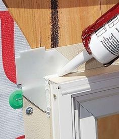 a paint can is being applied to the side of a window