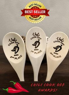 three ceramic spoons with chili logo on them