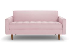 a pink couch sitting on top of a white floor