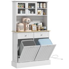 an open cabinet with two trash cans and other items in it on top of the shelf