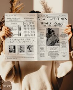 a woman holding up a newspaper with pictures on it