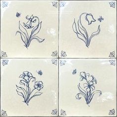 four blue and white tiles with flowers on them