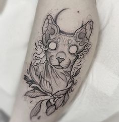 a black and white cat tattoo on the leg