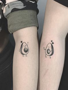 two people with matching tattoos on their arms