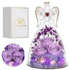 purple roses in a glass bell jar with angel wings on top and box next to it