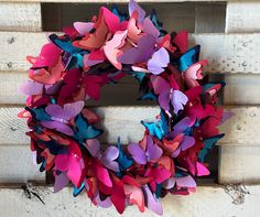 a wreath made out of colorful paper butterflies