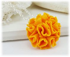 Petite hand sculpted 2cm marigold necklace on a hand wired bail. -Original hand sculpted polymer clay flowers -Durable, water-resistant -No molds, no paint, no glue -Flower Size : 2cm (about 3/4 inch) -16 inch or 18 inch chain -Silver-plated, Gold-plated, Antique Brass, 925 sterling Silver or 14k Gold Filled View matching collection at: https://www.etsy.com/shop/strandedtreasures/search?search_query=marigold Flowers are hand sculpted without molds or paint using polymer clay, a durable water-res Unique 3d Flowers Jewelry Gift, Yellow Flower Shaped Necklace Gift, Unique Orange Flower Shaped Jewelry, Unique Orange Flower-shaped Jewelry, Flower-shaped Orange Necklace For Gift, Orange Flower Necklace For Gift, Orange Flower Necklaces As A Gift, Yellow Flower-shaped Jewelry With 3d Flowers, Handmade Orange Flower Necklace