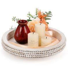 a tray with candles and flowers on it