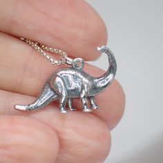 This 3D sterling silver brontosaurus dinosaur charm works great as a necklace or on a charm bracelet. 17mm long including jump ring 25mm wide We recommend a 1mm chain which is sold separately here. Product highlights: Made from 925 sterling silver. Comes in a black cotton filled jewelry box making it easy for gifting. Long Lasting & Worry Free. This item is solid sterling silver and is not plated or filled. Wear it in the shower, at the beach or wherever you go. Tooth Icon, Dinosaur Jewelry, Ring Icon, Chevron Earrings, Chevron Bracelet, Sagittarius And Capricorn, Jewellery Box Making, Chevron Ring, Box Making