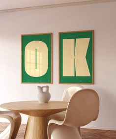 two paintings on the wall next to a table with chairs and a vase in front of it