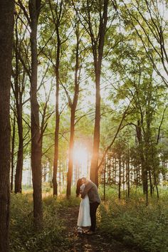 a bride and groom kissing in the woods at their sunset wedding photo by pmphotor