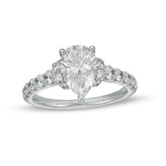 a pear shaped diamond engagement ring with diamonds on the band and shoulders, set in 18k white gold