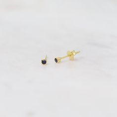 Classic deep-blue gemstone post earrings, perfect for a September birthstone gift! 2mm bezel set synthetic sapphire Gold plated over sterling silver Handmade in Thailand Hypoallergenic Sapphire Jewelry As Gift, Hypoallergenic Sapphire Jewelry For Gifts, Hypoallergenic Sapphire Earrings For Gift, Sterling Silver Earrings With Bezel Setting As Gift, Minimalist Sapphire Jewelry With Bezel Setting, Minimalist Sapphire Jewelry With Prong Setting, Dainty Earrings With Bezel Setting For Gift, Dainty Bezel Set Earrings For Gift, Blue Bezel Set Earrings For Gift