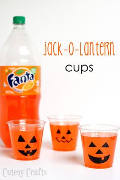 jack - o - lantern cups with orange juice and pumpkin faces on the side, sitting next to a bottle of soda