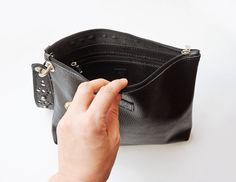 This beautiful leather wristlet bag is made of black leather with a beautiful luxurious handle, decorated with rivets and holes- choose color of metal hardware in drop menu . You can remove this handle and transform this bag into a minimal clutch. Bag has a zipper closure and one zipper pocket inside. Without lining Main color: black (there are also other colors available in our Etsy shop) Material: Black leather Zipper closure Removable leather handle Metal hardware- you can choose color in dro Elegant Bags With Rivets For Everyday Use, Evening Clutch With Wrist Strap, Leather Clutch Bag With Wrist Strap, Leather Evening Bag With Wrist Strap, Evening Leather Bag With Wrist Strap, Leather Clutch With Wrist Strap, Black Wristlet With Zipper Closure For Evening, Evening Black Wristlet With Zipper Closure, On-the-go Wristlet Clutch With Wrist Strap