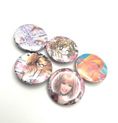 four buttons with pictures of the famous characters on them, all in different shapes and sizes