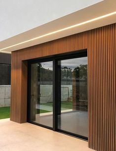 an empty patio with sliding glass doors and grass