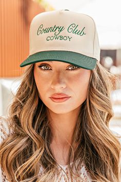 Calling all cowgirls! Elevate your style with our Country Club Cowboy Trucker Hat. Featuring an embroidered western graphic, this trendy hat is the perfect accessory to complete any casual outfit. Perfect for spring and summer, wear it to concerts and festivals for a chic and fashionable look. Available in 2 colors! Twill cap Made in USA Embroidery at front and side panel Adjustable back strap Brim measures approx 3" in lengthOS measures approx 23.55" in circumference Usa Embroidery, Gambler Hat, Rancher Hat, Trendy Hat, Cowgirl Chic, Western Chic, Beach Collection, Fringe Jacket, Top Graphic Tees